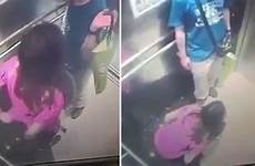 caught woman urinating cctv lift video mirror looks companion holds bag male