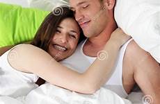 bed cuddling woman husband head chest smiling her women his stock preview