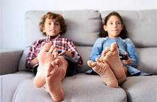 barefoot kids sofa playing game