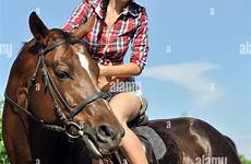 cowgirl riding young horseback horse stock alamy sunny composition rearing