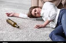 drunk woman floor lying unconscious bottle empty stock alamy