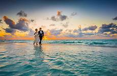 couple beach wedding sunset sea water honeymoon summer anniversary travel maldives vacation tropical ocean romance sand affair young sunrise seashore