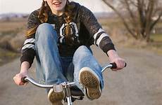 teen feet bike girl young rides handle bars stocksy teel tana