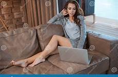 sofa sitting woman laptop young legs beautiful concentrate using dreamstime long serious preview