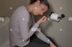 toilet sitting woman lid young her closed stock alamy