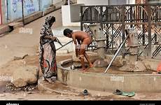 indian son mother washing village her fountain orchha madhya alamy