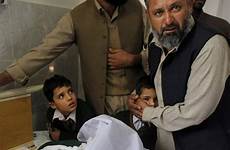 pakistani attack pakistan school boy taliban peshawar standing man children student cp24 comforts bedside dead injured hostage taken who dec