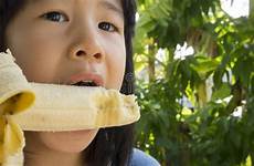 banana child asian bite eating girl eat joy chew little concept girls stock beauty preview similar