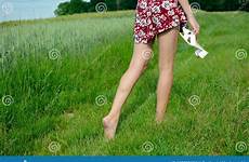 grass barefoot girl walks walking skirt slim holding colorful wearing shoes hand green her