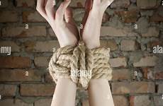 tied hands woman rope bondage alamy stock