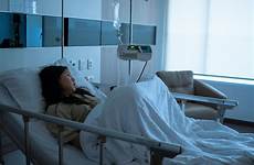 bed hospital sick woman patient lying young ward asian premium