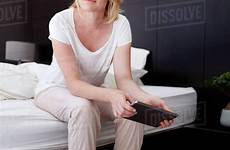 bed woman mature sitting beautiful bedroom stock portrait holding digital tablet dissolve lund jacob d2012