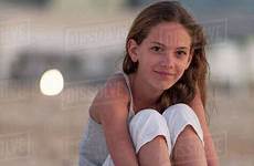 preteen girl beach sitting knees barefeet hugging girls stock photography d984