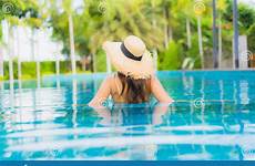 portrait asian happy young beautiful women relax swimming smile resort pool outdoor