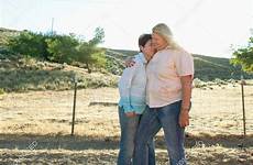 lesbian couple mature embracing ranch stock