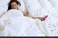 dildo holding woman stock shutterstock bed young
