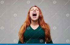 screaming redhead woman negative expressing emot loudly stock