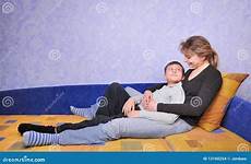 boy teen woman sofa sits smiling preview