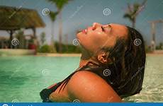 swimming indonesian tropical exotic bikini enjoying resort pool luxury asian island woman happy young beautiful summer portrait bliss