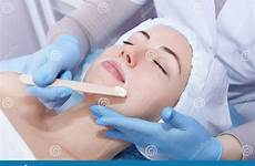 depilation wax hot beauty salon mustache epilation beautician closeup receiving removes facial woman young hair