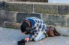 homeless man knees begging his money prague cold tourists charles bridge spring poor people kneeling