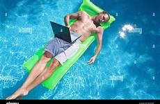 laptop raft sleeping floating man inflatable stock alamy