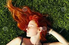 sleeping redhead girl stock lying grass hair