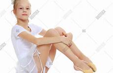 little girl gymnast cheerful sitting knees dress floor her posing hugging front stock