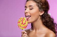 licking beautiful lollipop portrait young women woman closed stock