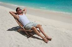 sunbathing beach man chair sea relaxing island near stock depositphotos maldives