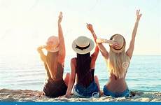 beach girls having fun group dawn ocean happy hats