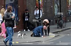 humiliated man publicly dominatrix being stock streets alamy