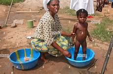 child alamy mother nigeria africa stock bathes buy