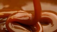 Caramel dripping thick strand. Slow motion.