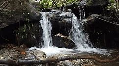 small cascade waterfall streaming splashing