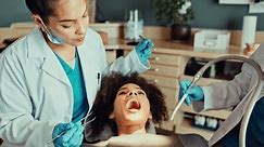 Checkup, dentist and patient in office for clean, equipment and tools for healthcare and dental health. Oral hygiene, gloves and doctors with woman, exam and ready for teeth whitening for client