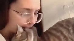 Glasses girl bites cat after get bit