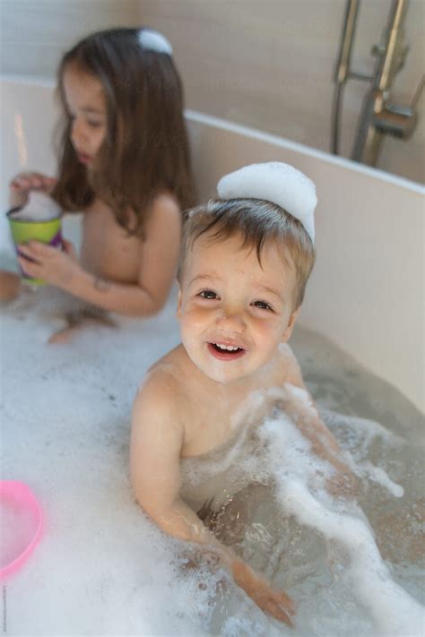 Babies change a lot in the first year of life, so baby bathtubs are designed to accommodate them at different stages in their development. Cute boy toddler playing in a bathtub by Jakob Lagerstedt ...