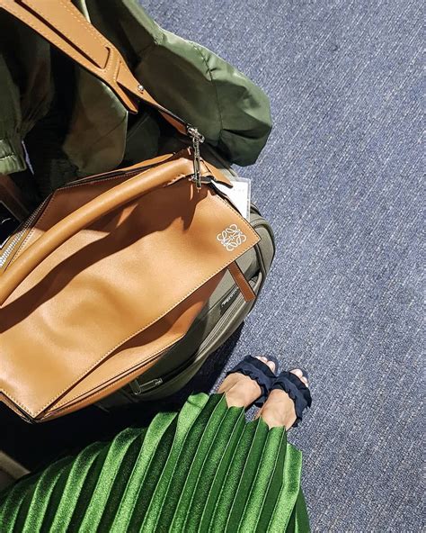 Carried by everyone from kate moss to sarah jessica parker, the bag is precisely. loewe puzzle medium tan, green accordion pleated skirt ...