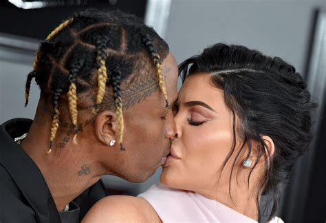 Blonde and brunette press flesh and fondle curves. Kylie Jenner & Travis Scott Kiss On The Grammys Red Carpet