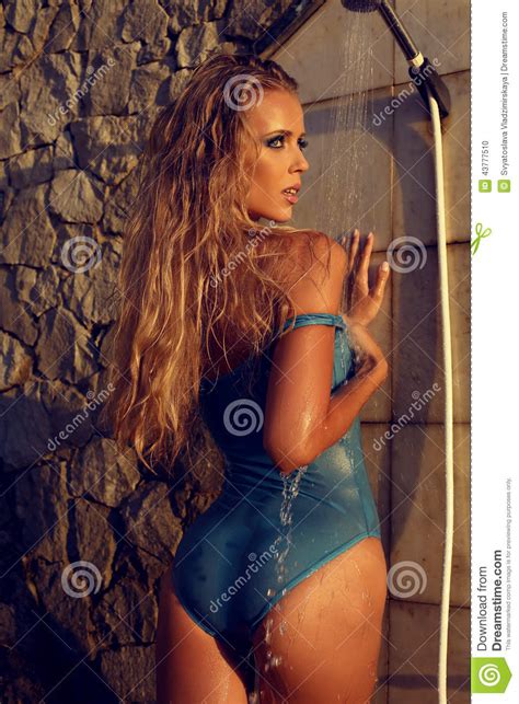 The setting is nearly as intriguing, as it can easily be presented in a manner of having its own sinister, dark role in the story. Girl With Blond Hair Taking Shower On Beach Stock Photo ...