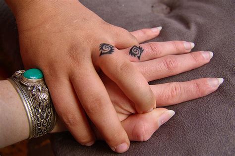 The skin on the inside of the hand—and fingers—is notoriously difficult to tattoo and ink placed on the inside of the finger often falls out leaving a faded remnant of the original design. Wedding Ring Tattoos - Top 10 Must-Know Tips (and Pics!)