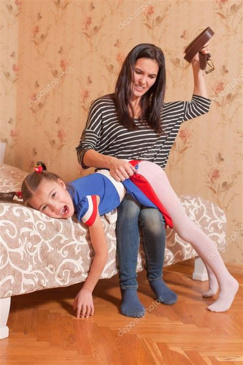 I just enjoy spending time with them. Mother trying to hit daughter with belt — Stock Photo ...