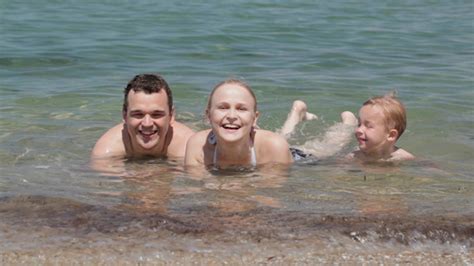 For over 16 years we have been promoting naturism. Young Family in the Sea by Grey_Coast_Media | VideoHive
