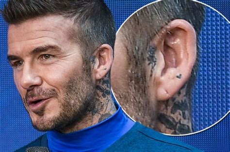 The back of the photo of david beckham visible tattoo with a cross with wings and the name of the second son of «romeo». David Beckham unveils new tiny tattoo as fans speculate it ...