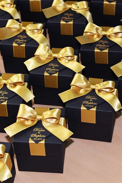 These wedding favor boxes and favor bags are perfect for holding treats or small trinkets and will delight your wedding guests. 24 Black & Gold wedding favor gift box with satin ribbon bow | Etsy in 2021 | Gold wedding ...