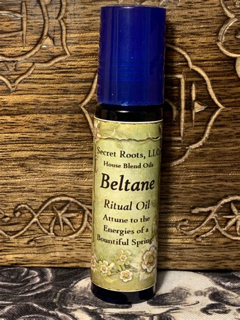 Two white candles for deities; Beltane Ritual Oil