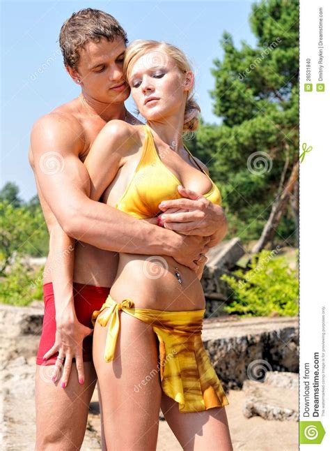 Personalized search, content, and recommendations. Man And Woman Holding On The Beach. Stock Photo - Image of ...
