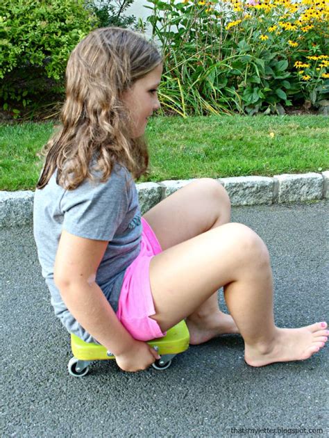 Tee ngirl sitting on old cart at train station. DIY Kids Scooter