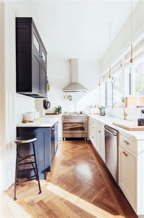 Toile fabric and wire mesh inserts were added to the upper doors to lend charm and to break the monotony of a solid. Narrow Kitchen Designs To Use The Space In An Efficient Way